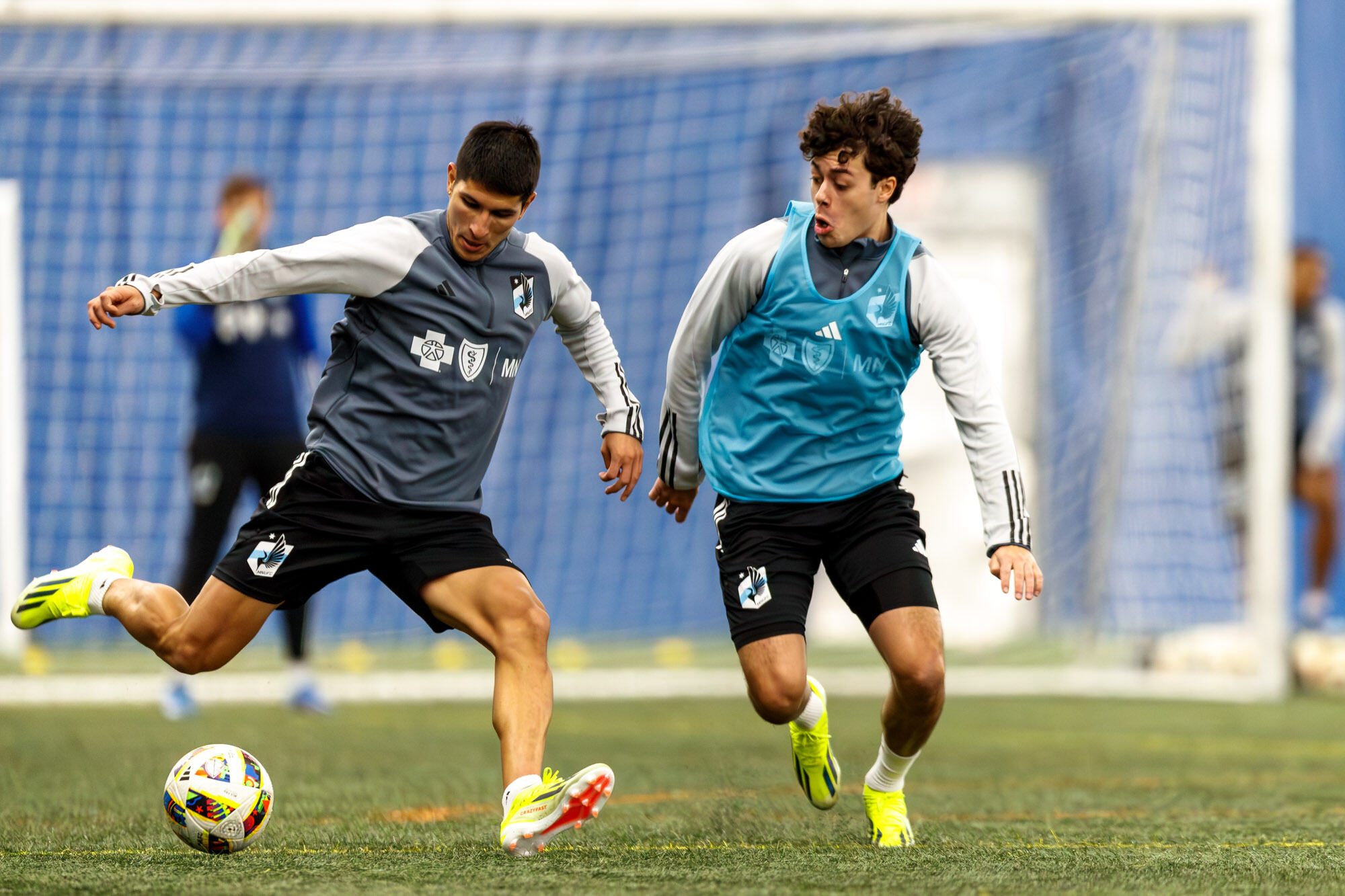 Miguel Tapias pulls back his right leg to kick the ball as Caden Clark defends.